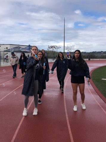 SJHHS students smile together as they walk around the track in the rain at the 2020 Walk for Wellness.