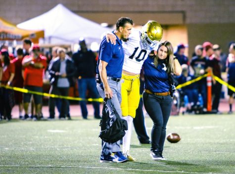 San Juan Hills Head Athletic Trainer Micah Ohlen helps Senior Max Difilippo off the field following a knee injury. While Micah is certified himself, he is concerned about California's lack of a regulating and licensing body for Athletic Trainers.