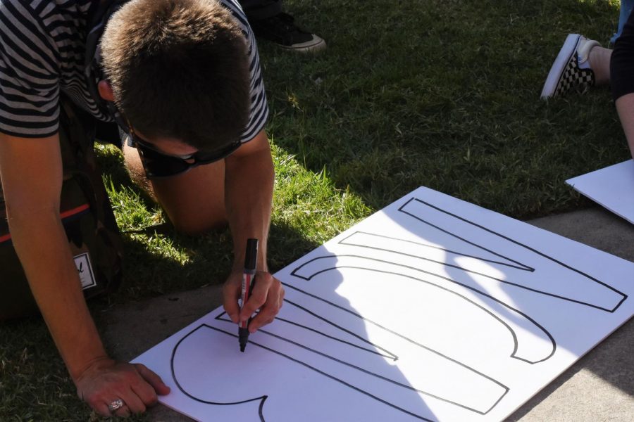 During the San Clemente Black Lives Matter Protest, a protester writes "ACAB" on a sign. Throughout the protest, people carried signs that showed their support for the Black lives matter movement.