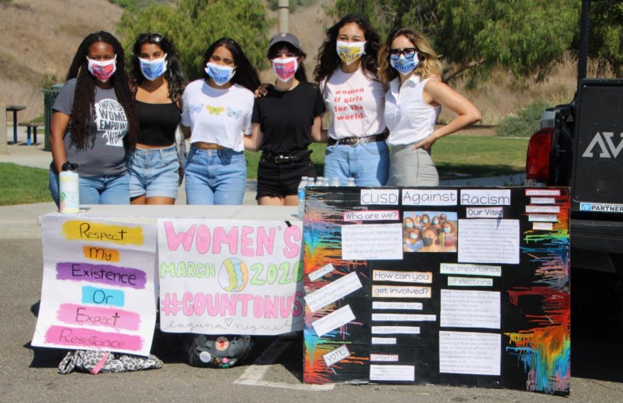 Members of CUSDAgainstRacism pose with candidate Jasmine Funes at the end of the women's march. 