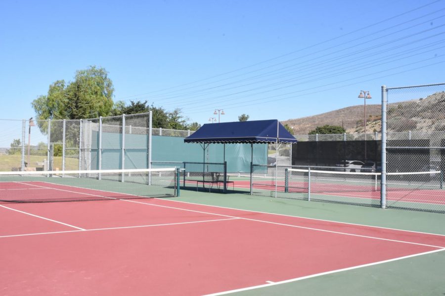 While the tennis courts on campus appear to vacant, players will bounce back into action as tryouts take place at the end of the month and as team practices safely begin again.