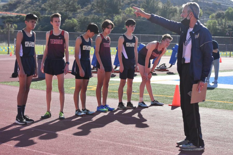 Before+the+meet+began%2C+cross+country+coach+Bob+Price+explains+to+the+runners+what+the+course+will+be+for+their+race.+The+race+began+on+the+track%2C+the+athletes+would+run+to+the+teachers+parking+lot%2C+go+up+the+teachers+entrance+to+the+parking+lot%2C+circle+around+the+hill+and+around+the+LDS+church%2C+repeat+the+loop+around+the+hill%2C+then+go+back+to+the+track%2C+and+run+550+meters+to+finish+the+race.