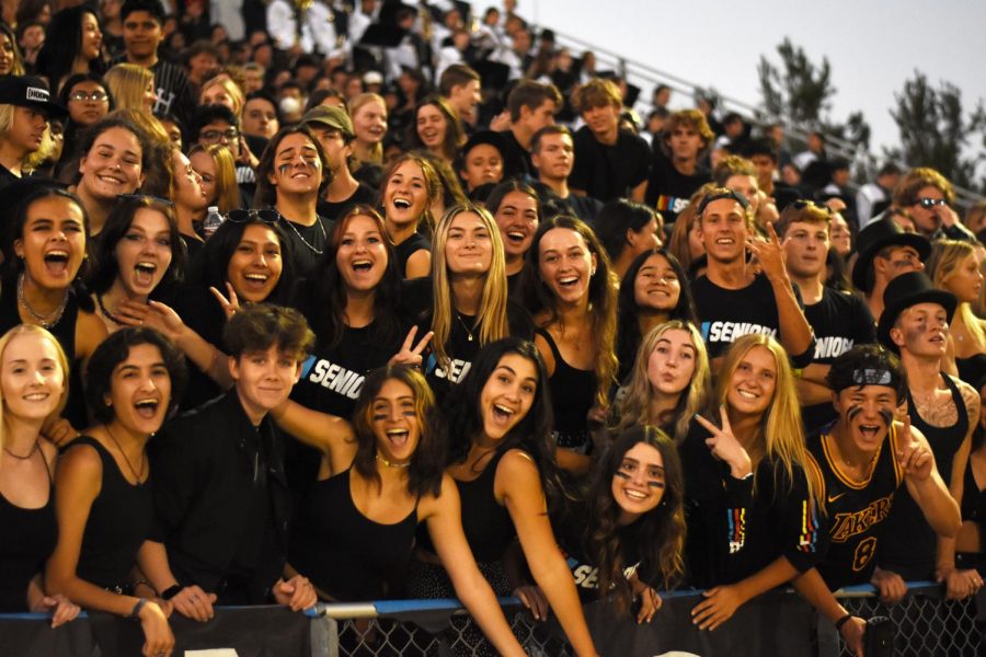 Seniors in the student section make some noise and show off their spirit with their class shirts. Students wore all black, honoring senior night as well as the game’s theme, “lights out.”
