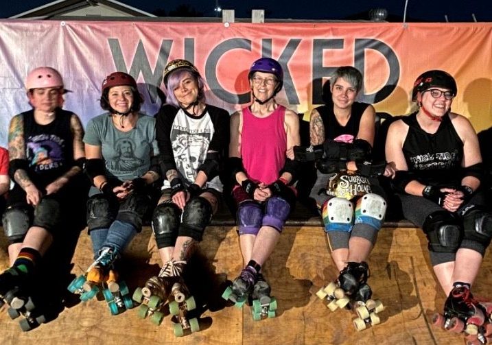 The High Tide Roller Derby team, with members Danielle Flint, Kaitlin Naccarato, Chelsea Skoien, and Thara Foster poses for a photo at one of their events.  