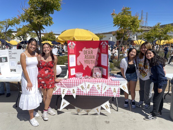 The leadership council for Dear Asian Youth pose for a photo during the Club Rush, as they advertise their organization and mission.