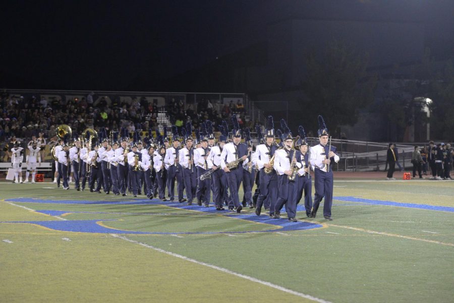The marching band walks on the field to play the national anthem for the homecoming game. They play at every game and will preform the half time show again at the Mission Viejo game on October 22.