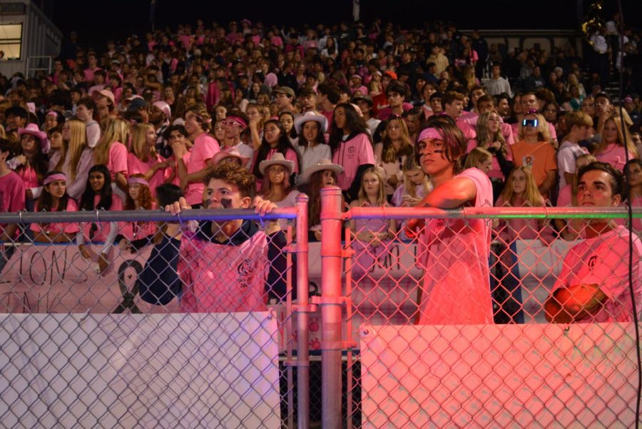 Decked out in pink, spirit members Caden Berry, Garrett Moreno, and David Engle watch the football game. The entire crowd wore pink to honor Breast Cancer Awareness Month.