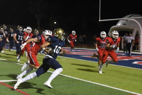 Quarterback Michael “Butter” Tollefson (10), rushes the ball towards the end zone. Despite being surrounded by opposing defenders, Tollefson’s carry results in the first Stallion touchdown of the night.