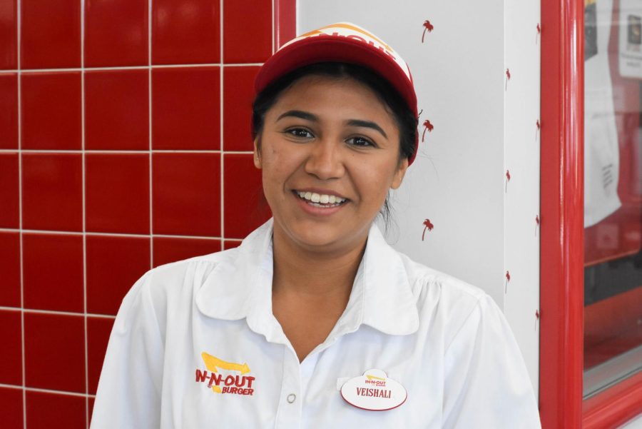 Student and In-N-Out employee Veishali smiles during her shift. In-N-Out workers are often bombarded during the post-football game rush, making it a tough yet rewarding job.