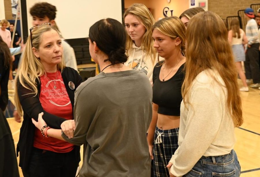 Students approach Amy Neville in the gym after one of three assemblies conducted to warn about the dangers of fentanyl. Neville’s son, Alexander, died in 2020 of  fentanyl poisoning. Fentanyl deaths have increased dramatically since 2013 when it accounted for 3% of drug deaths. Now it represents more than 50%.
