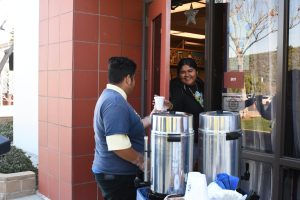 A student in the STEPS program delivers a beverage to a classroom.  The students learn real life skills, including social abilities, independence, working with money, and budgeting. 