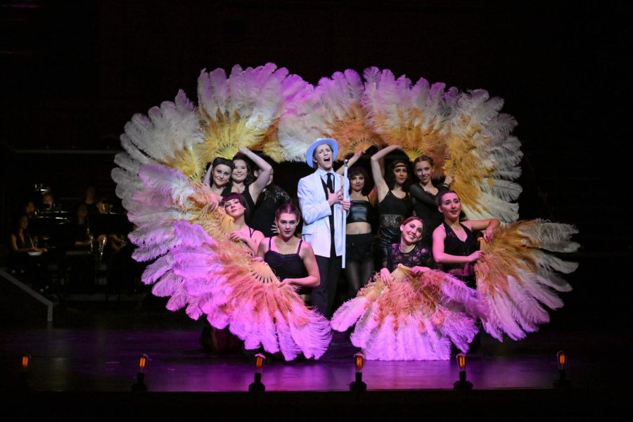 Surrounded by dancers and colorful feathers, Billy Flynn, played by Jacob Koclainis (11), sings the song “All I Care About is Love” in the Stallion Theatre Companys teen-version production of Chicago. The Spring musical follows Roxie Heart, played by Peyton Kirkner (12), a murderer who tries to free herself after being convicted and sent to jail. Billy Flynn, Roxies defense attorney, paints himself as considerate and thoughtful despite his underlying selfish and greedy motives. This number details Billy’s “only” motivation for being an attorney: his love of women. This proves to be a lie later in the show.