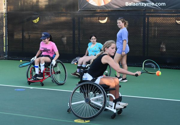 Nellie Foulger smashes a backhand at a T3Tennis on Wheels clinic. The focus of this drill is mobility on backhand deliveries