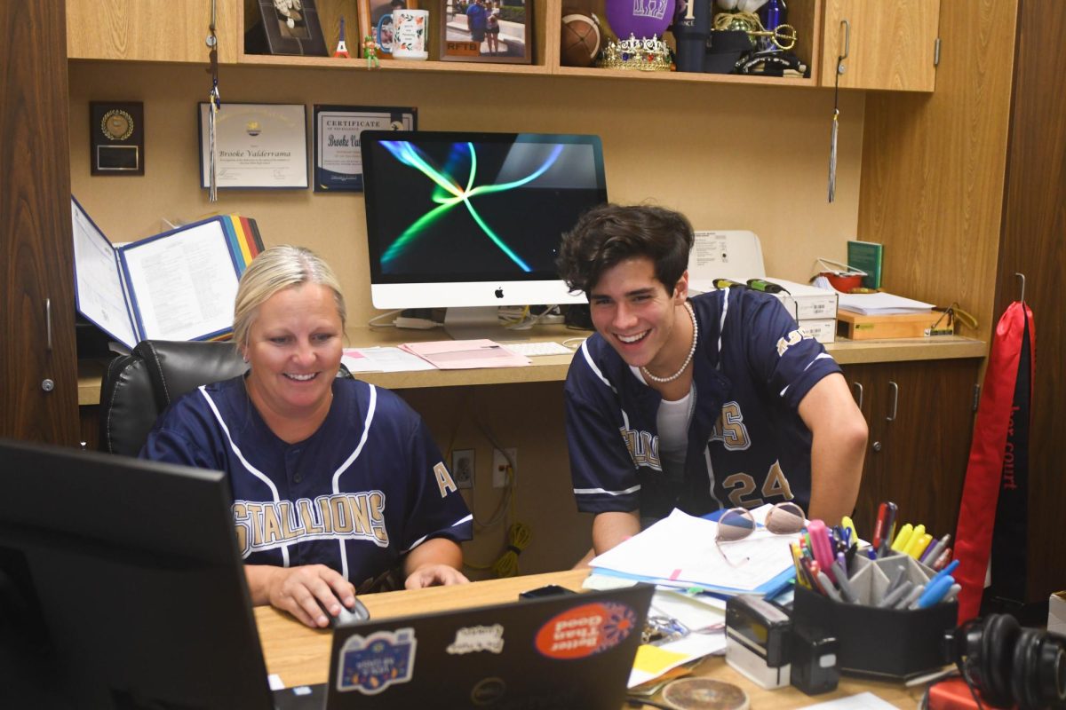 Reviewing receipts from the Homecoming dance, Brooke Valderrama and Senior William Meshkin laugh as they pass the time doing tedious work together. Valderrama often engages with the student body while conducting her work, finding not only their insight useful but their company a treat.