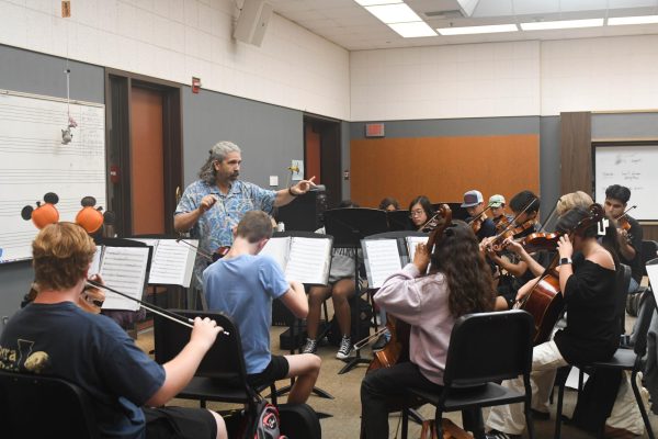 Carefully conducting a freshmen class, Dean McElroy ensures they will be ready for their next concert. The students who are willing to go the extra mile will continue down a path of success in the world of instrumental music in McElroys award-winning groups.