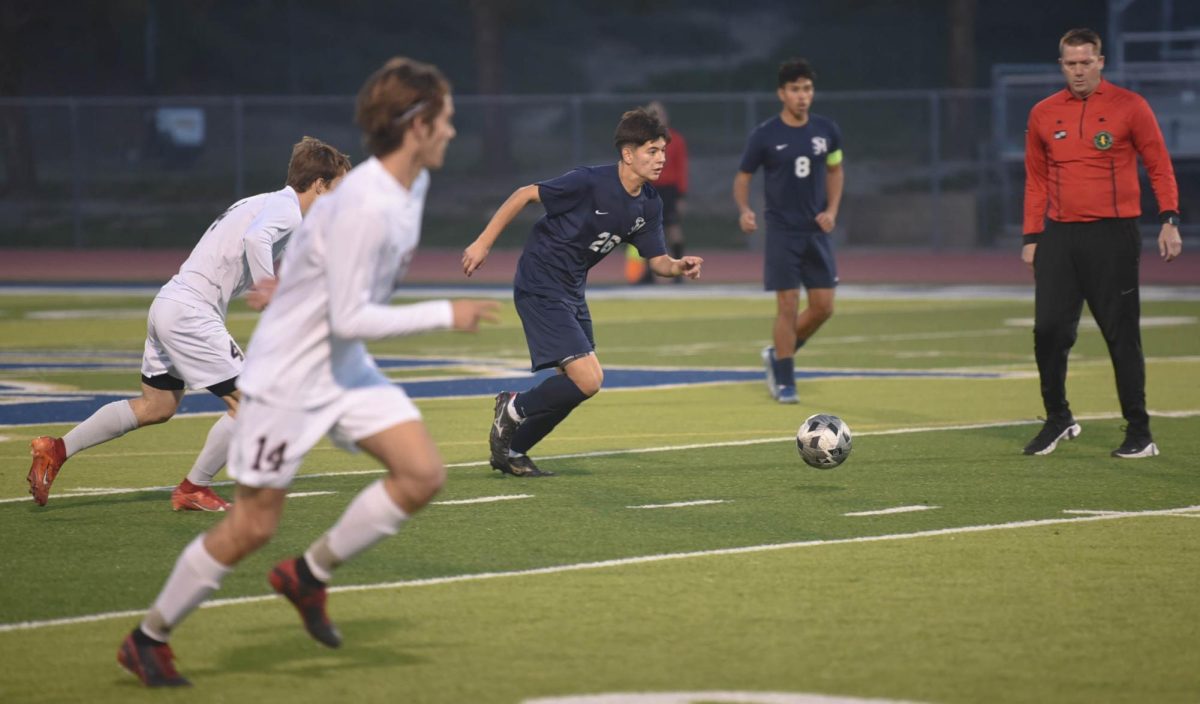 Andrew Bahena (12) dribbles the ball in the midfield of The Badlands. SJHHS ended falling to the Tritons 4-0 in an eventful league match. The Stallions currently sit in third place in league standings.