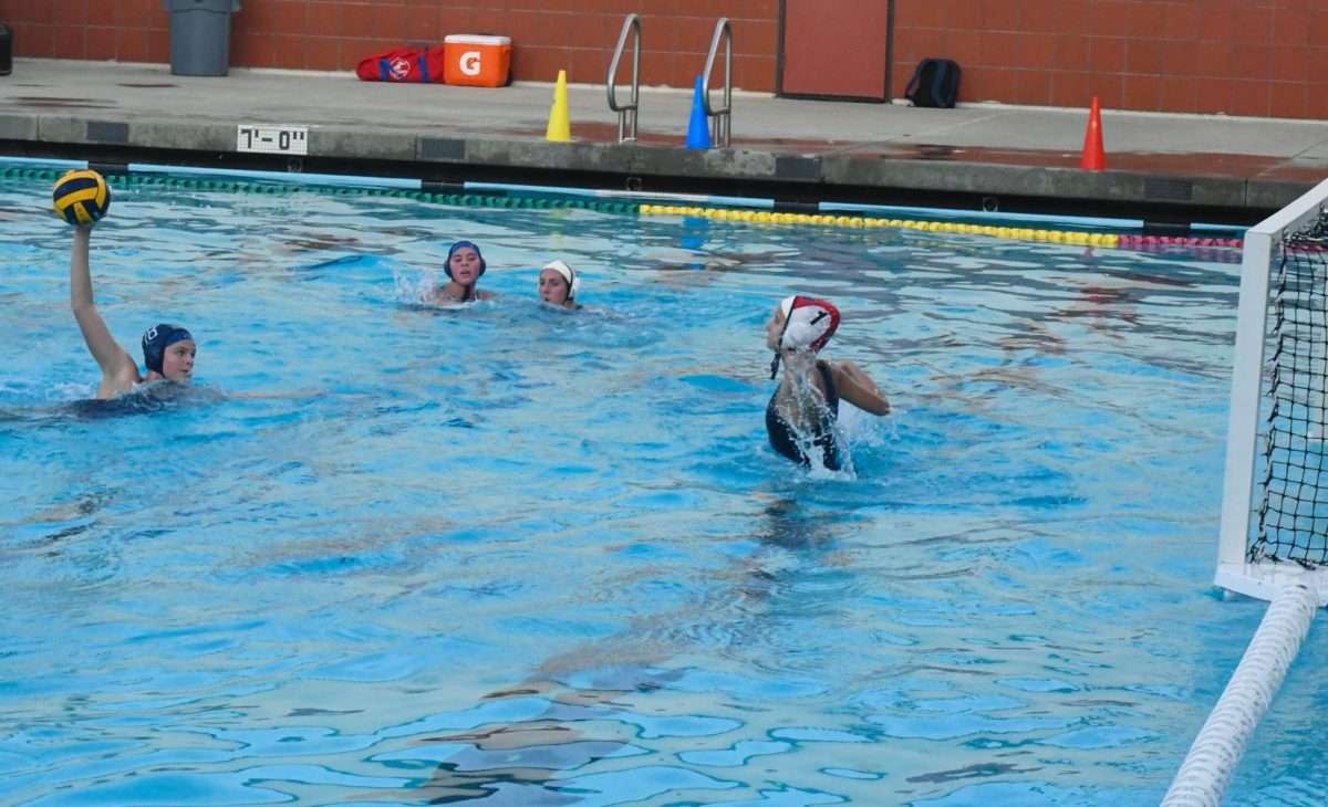 Eliza Walburger (10) winds up to throw the ball into the net. Girls varsity water polo played Trabuco Hills High School on January 18th and won the game, with the final score being 10-5.