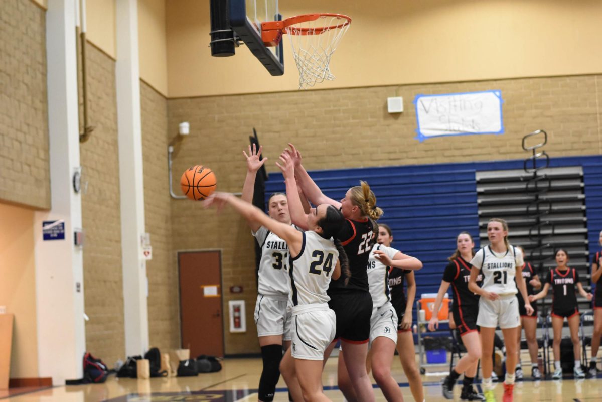 Girls Basketball players 33 and 24 blocking San Clemente High School from scoring. Our school won with 47 and 30 points.