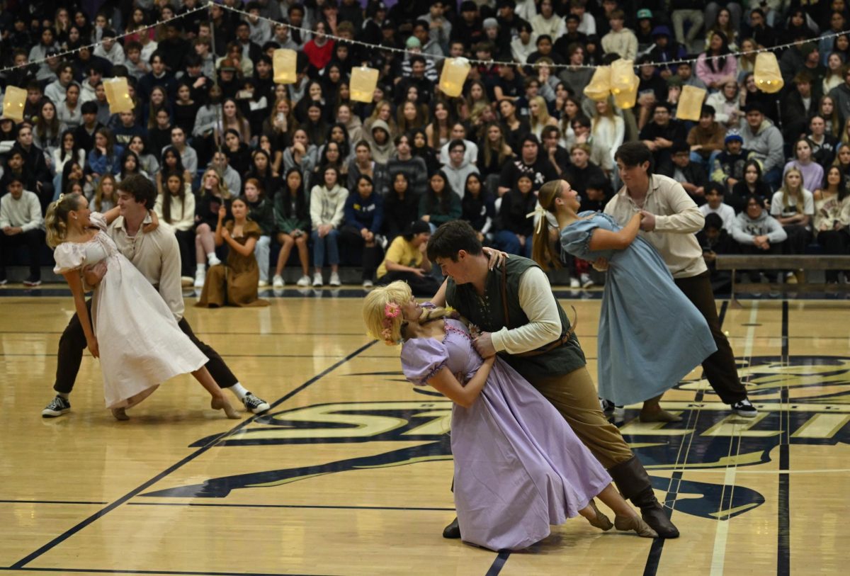 Rapunzel, Hannah McCabe (12), and Flynn Rider, Jake Javorsky (12), perform a dip in the final moments of the Dance team’s performance for the Rapunzel themed pep rally. Background dancers Weston Port (11), Summer Lewis (12), Cooper Javorsky (10), and Savannah Stull (12) accompany. This scene resembles the floating lanterns scene in the movie, where Flynn and Rapunzel finally embrace each other.