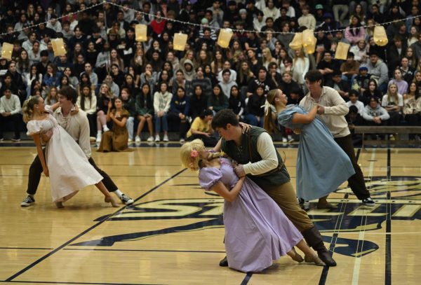  Rapunzel, Hannah McCabe (12), and Flynn Rider, Jake Javorsky (12), perform a dip in the final moments of the Dance team’s performance for the Rapunzel themed pep rally. Background dancers Weston Port (11), Summer Lewis (12), Cooper Javorsky (10), and Savannah Stall (12) accompany. This scene resembles the floating lanterns scene in the movie, where Flynn and Rapunzel finally embrace each other.