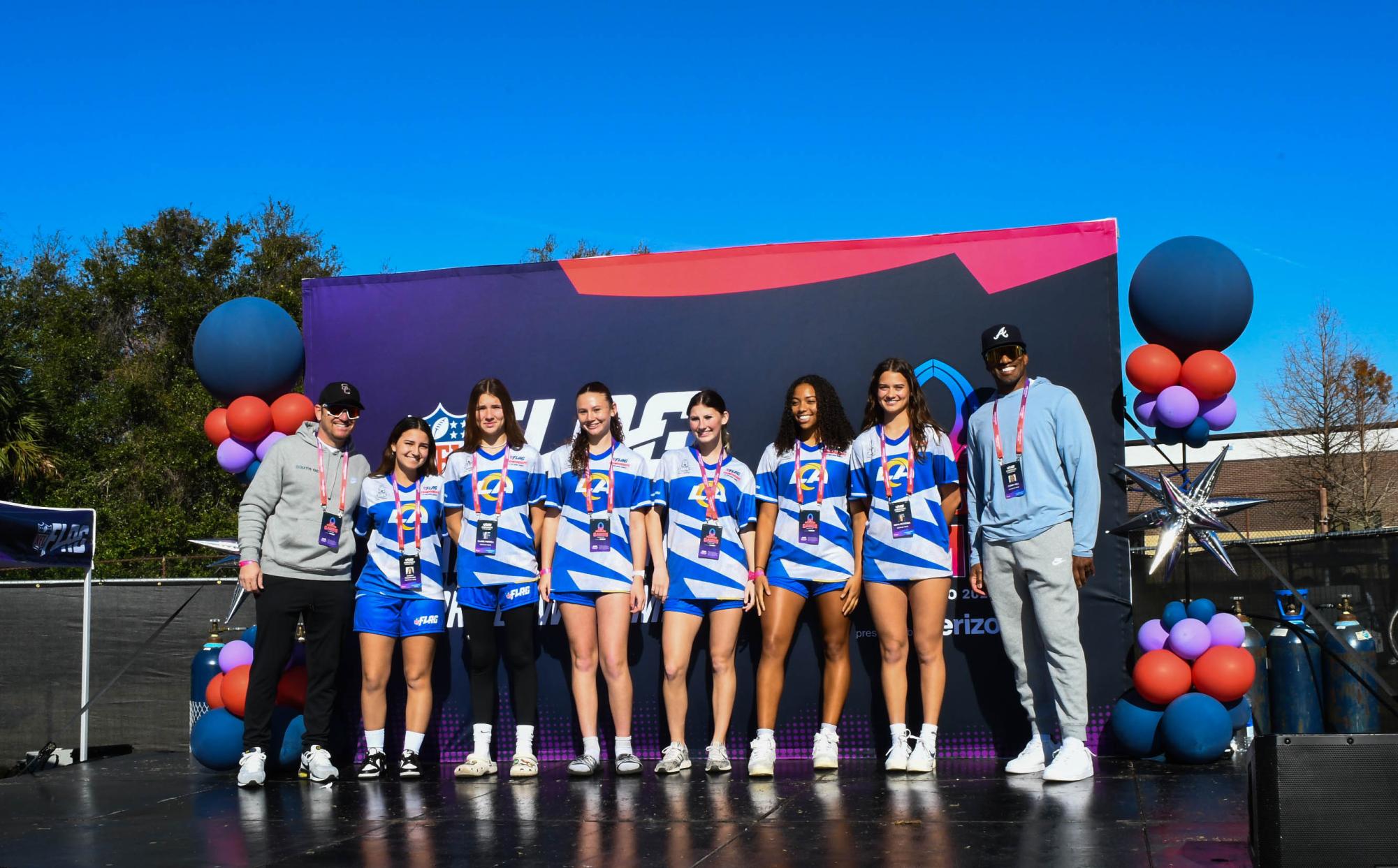 South OC Wave 17u girls team smiles as they were honored on stage in Orlando, Florida. The team has four players from San Juan Hills, one player from Trabuco Hills, and one player from Mission Viejo High School all coming together to represent the Los Angeles Rams. 

