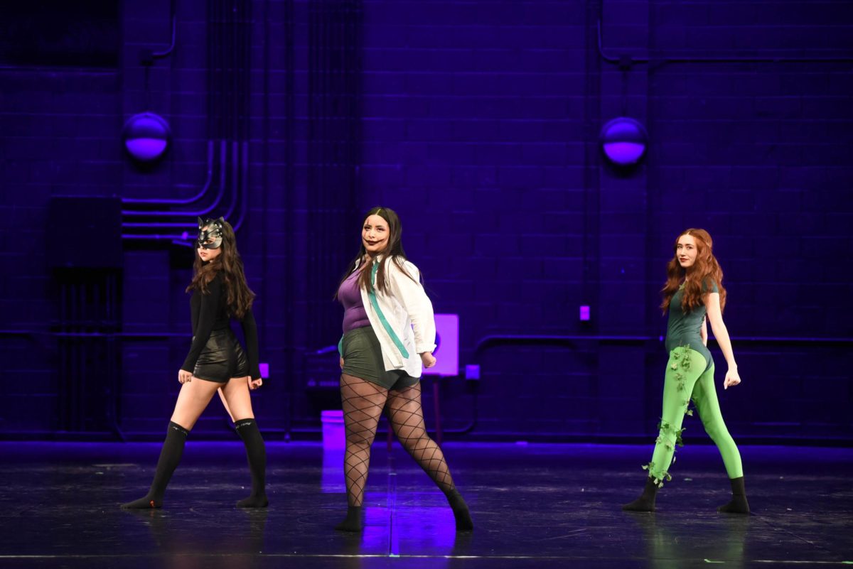Posing in their Catwoman, Joker, and Poison Ivy costumes, Jacqueline Kohl (12), Noemi Gonzalez (12), and Alexa Delgado (11) show off their moves in their DC Comics-inspired jazz number.  