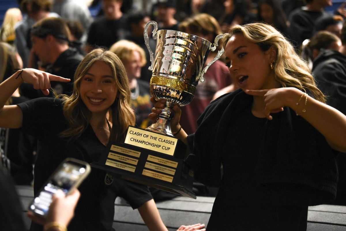  Winning Clash of The Classes Kennedy Canizales (12) and Makenna Reiter (12) are full of enthusiasm as they point to the champion cup that the seniors have won for another year.