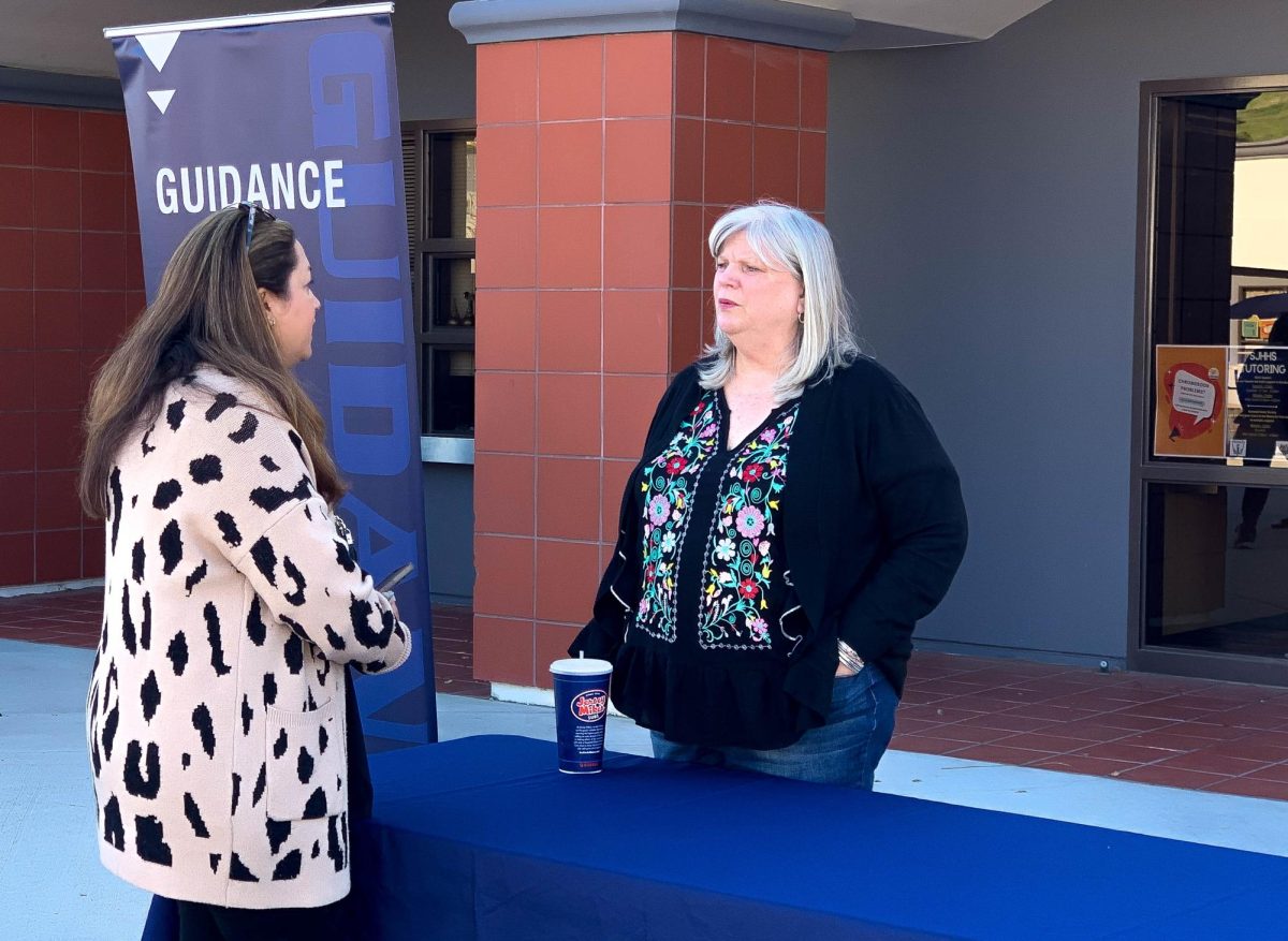 School counselor Maureen Scherf talks with a parent during Open House. This event took place on March 28th in the upper quad, where family members of SJHHS students were able to meet with teachers and discuss the events of the school year.