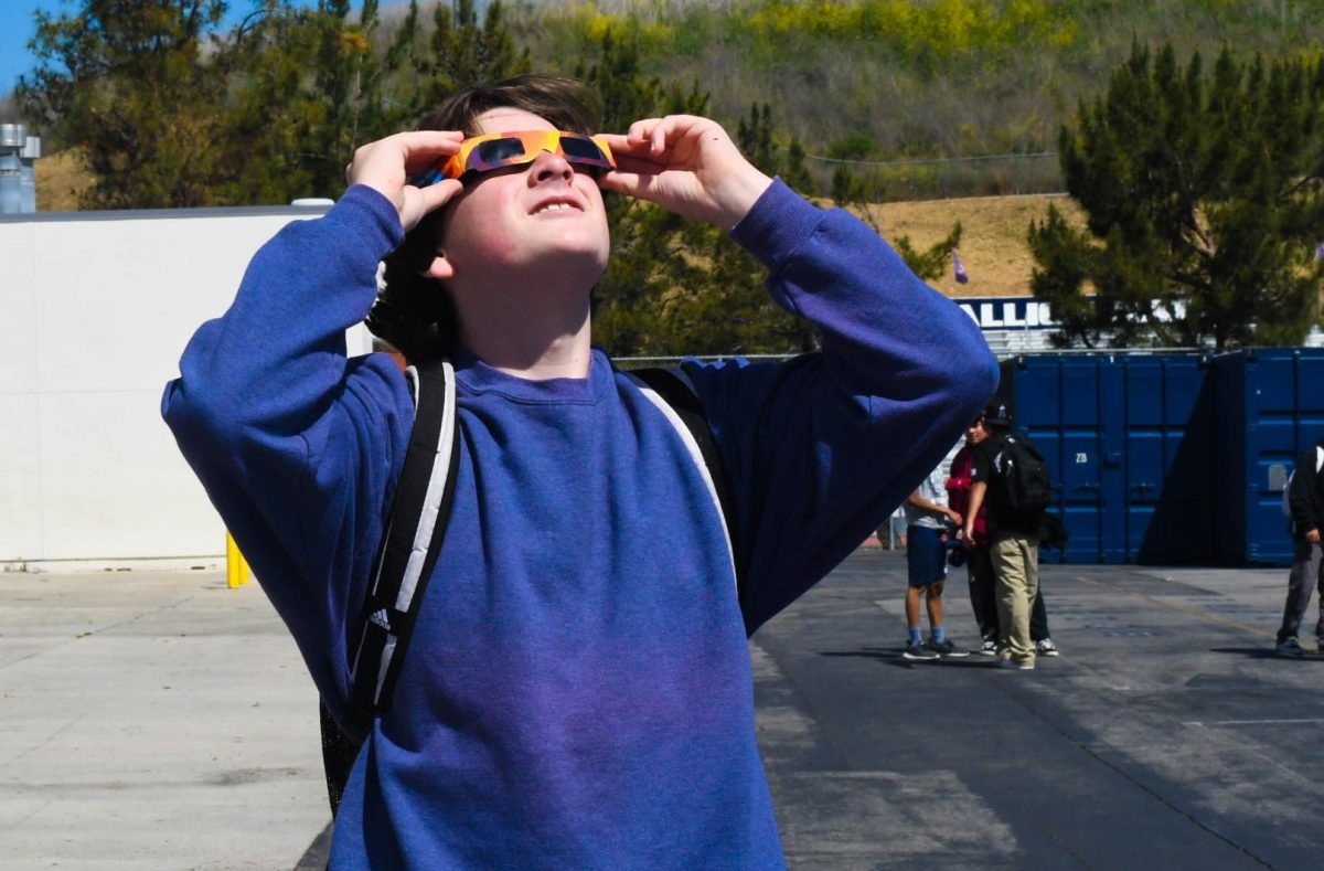 After spring break, David Hawley (10) gazes up at the sky wearing protective glasses to see the extraordinary solar eclipse.This is the first solar eclipse to sweep across North America since 2017 and there won’t be another until 2044.