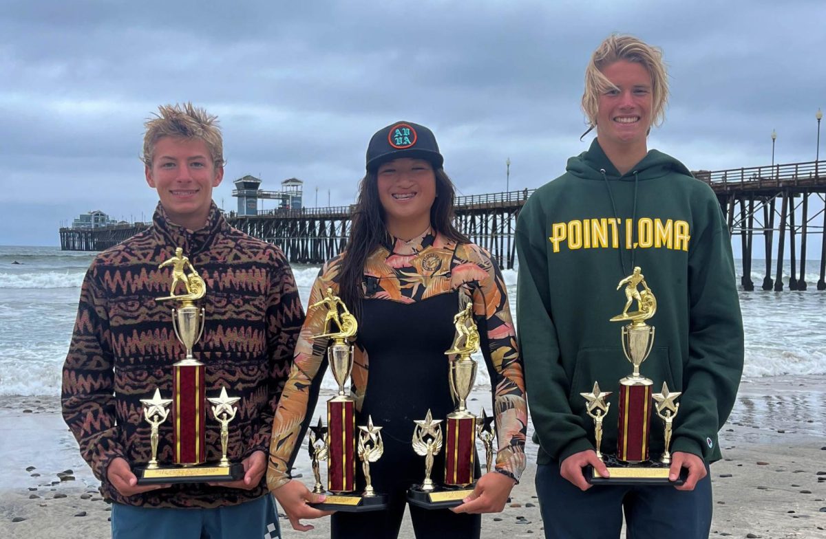 Gage Schroeter (10), Gwyn Lyon (10) and Ethan Howard (12) hold the hardware they won proudly at Oceanside. Schroeter and Howard won in Longboard competition while Lyon won in both the Longboard and Shortboard. 
