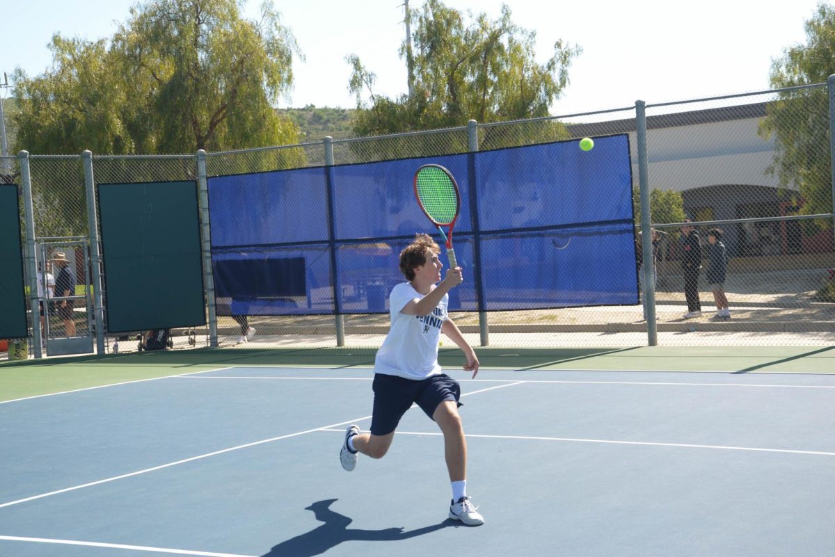 Chasen Colwell (12) runs to volley the ball during his match against San Clemente. This match was the last of the regular season as well as Senior Night, honoring the 9 seniors on San Juan Hills’ Boys Tennis Team.