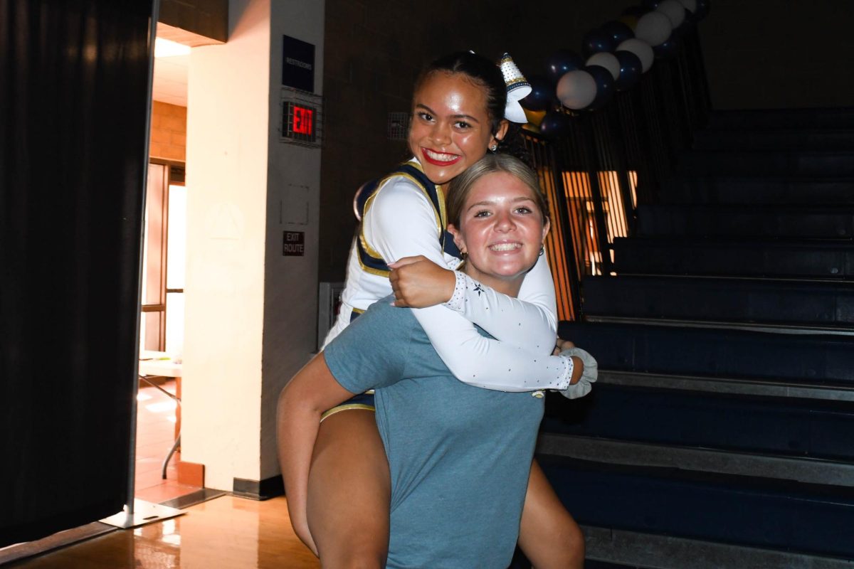 Posing together with bright smiles, JV Song member Ava Alaniz (9) and ASB Freshman Representative Makena Malinauskas (9) show off their Stallion spirit. Minutes before the first pep rally, ASB members must make final touches to their decorations, and Pep Squad members must prepare for their high-energy performance. 
