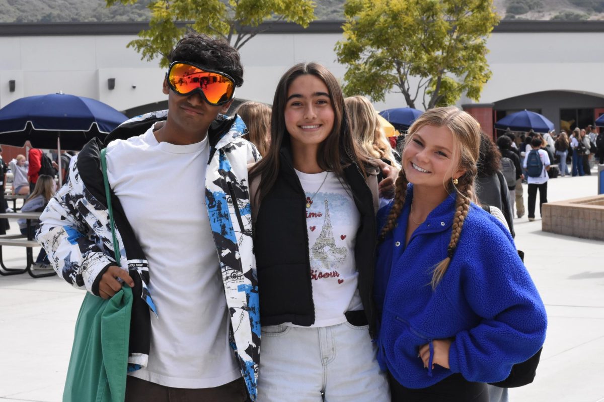 Sidharth Gaikwad, Hope Khalili, and Hailey Palmer demonstrate their school spirit with their ski day outfits. To create anticipation for the Homecoming game and dance, SJHHS students participate in dress-up days.