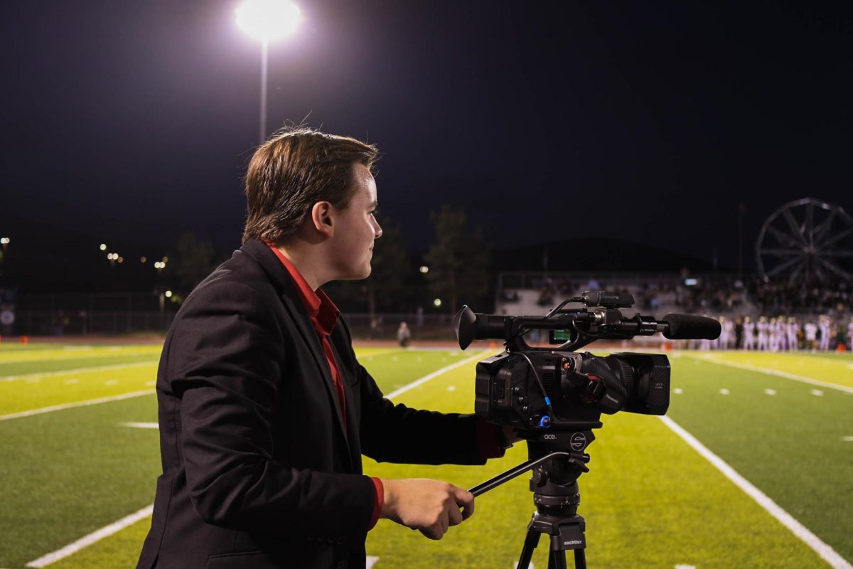 Attentively recording the Homecoming football game, Shane Roberts (11) gathers content for The Mane Event. Roberts not only recorded testimonials from players, but also gathered excellent footage of the game itself. 
