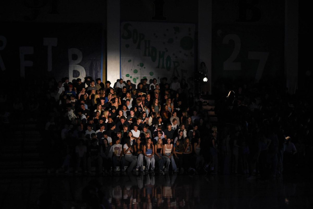 Patiently awaiting the pep rally to begin, the sophomore student section brims with anticipation. In an effort to build excitement, ASB dimmed the lights and had a series of spotlights illuminating the students. 