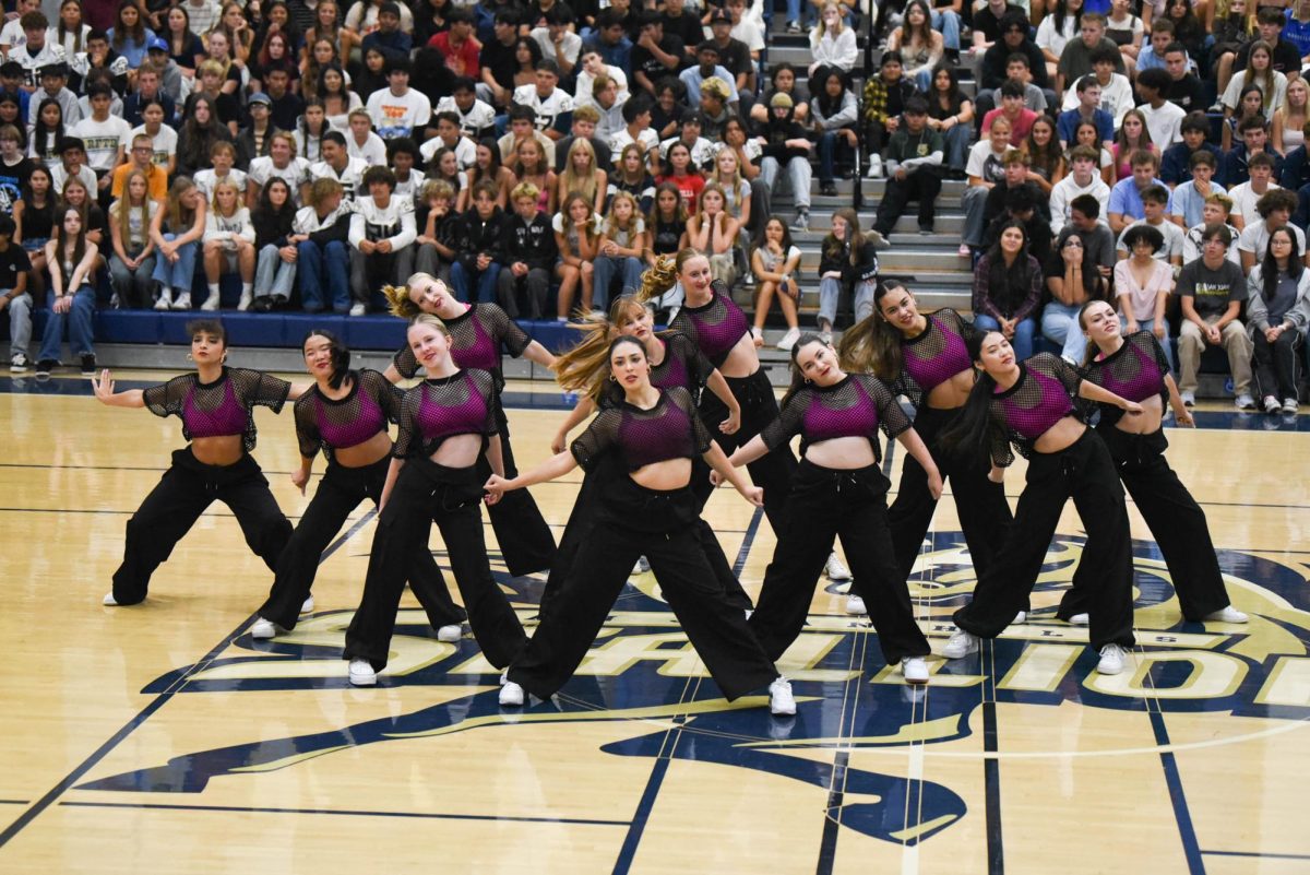 Strutting the gym floor, Intermediate Dance energizes the crowd while they perform their up-beat dance combo to a remix of “Girls Just Want to Have Fun.” 
