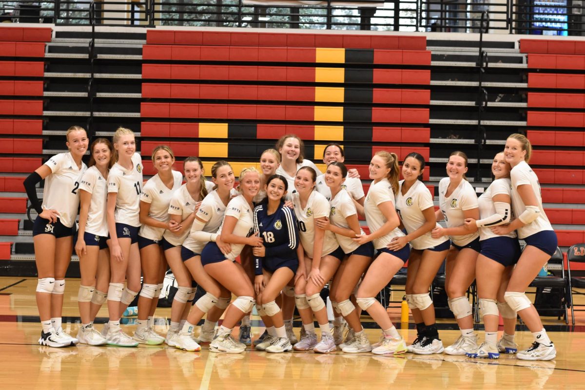 Girls varsity volleyball joins together in a group photo at an away game at JSerra High School. The game ended with a score of 3-1 in favor of the Lions.
