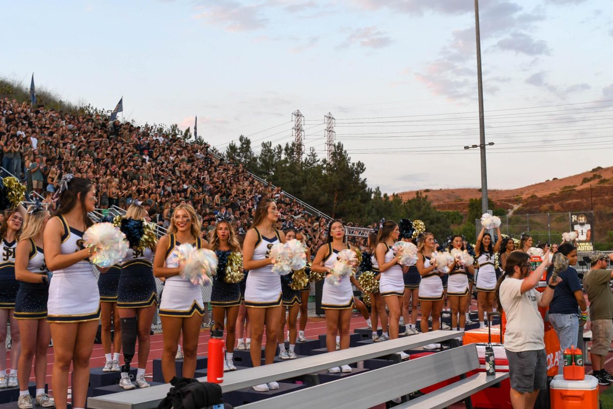  Haven Warther (11), Peach Miller (11), Sienna Hardin (11), and Kayla Tran (12) cheer on SJHHS varsity football. During the game, the Cheer and Song team is in charge of keeping the SJHHS fans energized and engaged in the game.