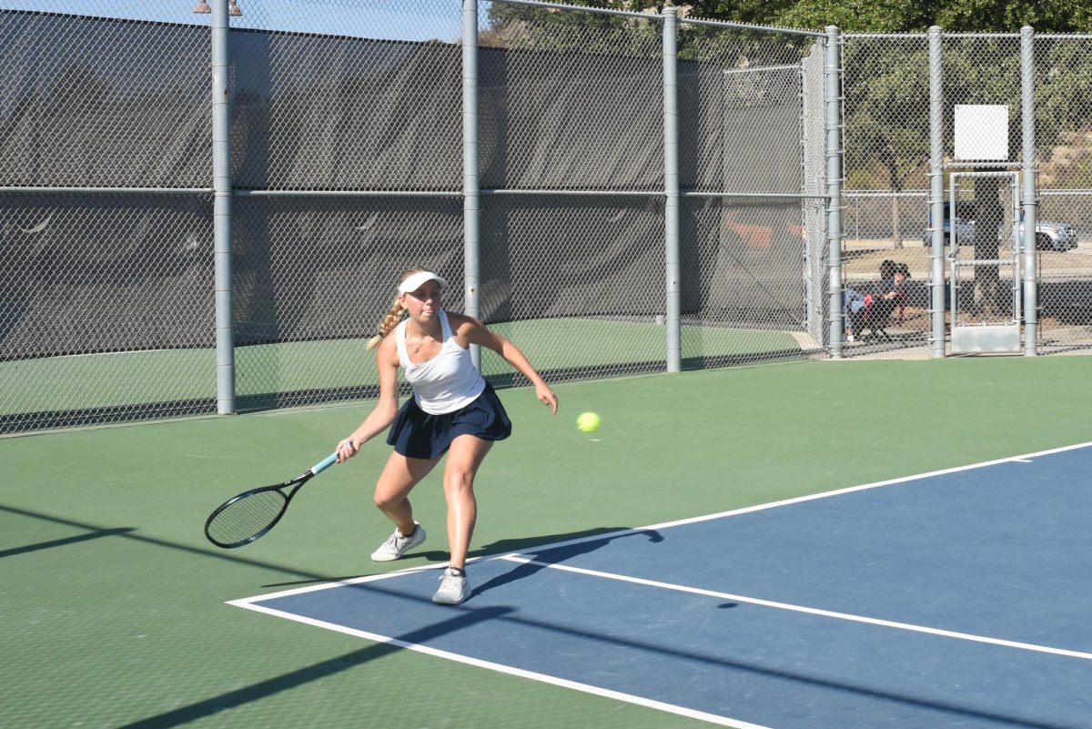 During a heated match, Ayla Gelsinger (11) aims for the ball in her match against Beckman. In the end, the game favored the Patriots with a final score of 13-5.