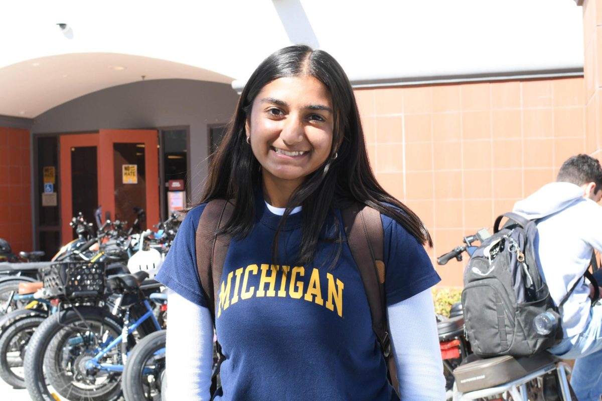 With a bright smile, Aleena Ali (12) wears her University of Michigan shirt with pride. College application season is here, and to remind students of their applications, students were encouraged to participate in the college gear dress-up day.