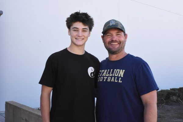 Luke Frith (10) posing with coach Frith, head coach in football, who also happens to be his dad. There are harmful misconceptions of athletes who are related to their coaches thinking they get better treatment. In reality athletes who have a parent as their coach often get the shorter end of the stick.
