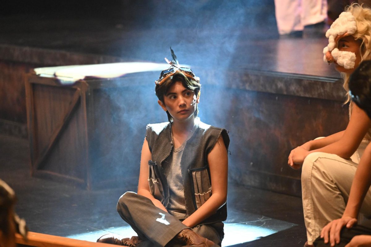 During dress rehearsal, Clay Wittman (12) sits in preparation to act out his piece of the act. Clay plays the role of the pigeon, a messenger for the farm. 