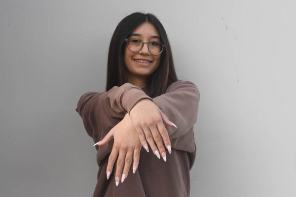  Student nail technician, Morgan Beaver (11) displays her newest set of nails. Beaver runs her own nail business where she creates gel-x nails similar to the ones she has on. 