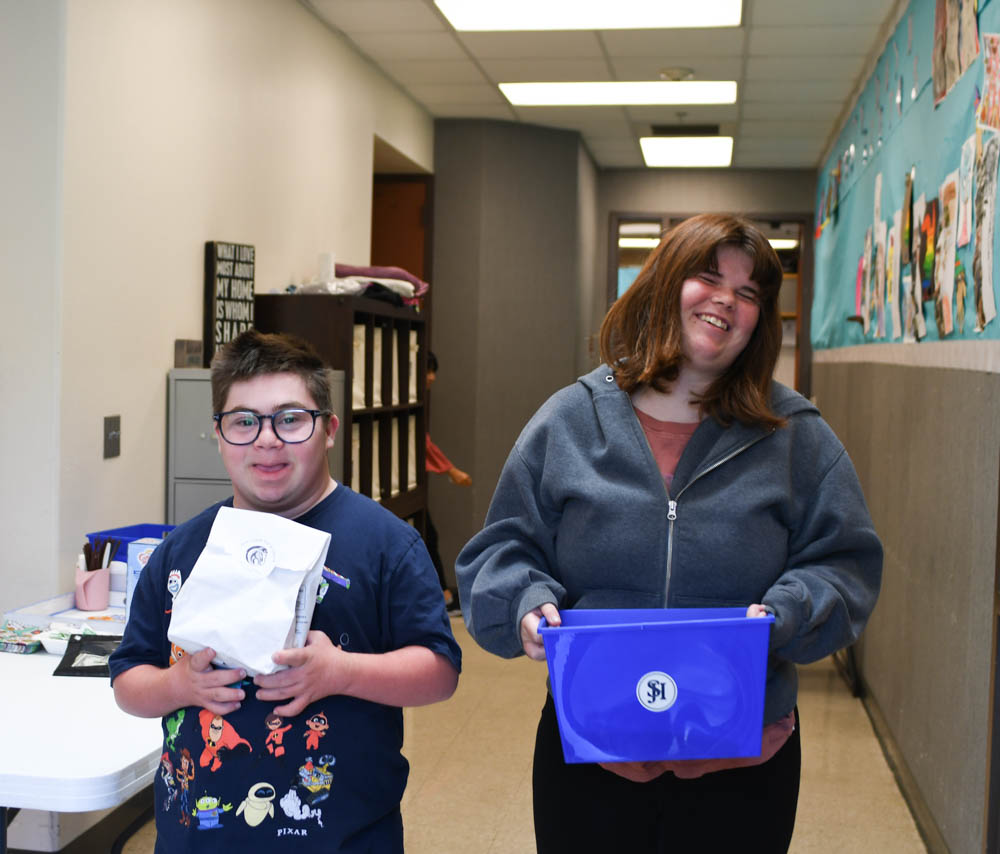 Steps members, Paul Freeman (11) and Addy Hayes (12), prepare snack orders to deliver to staff members of SJHHS. Sip’n snack allows the STEPS program to create baskets for their fellow teachers