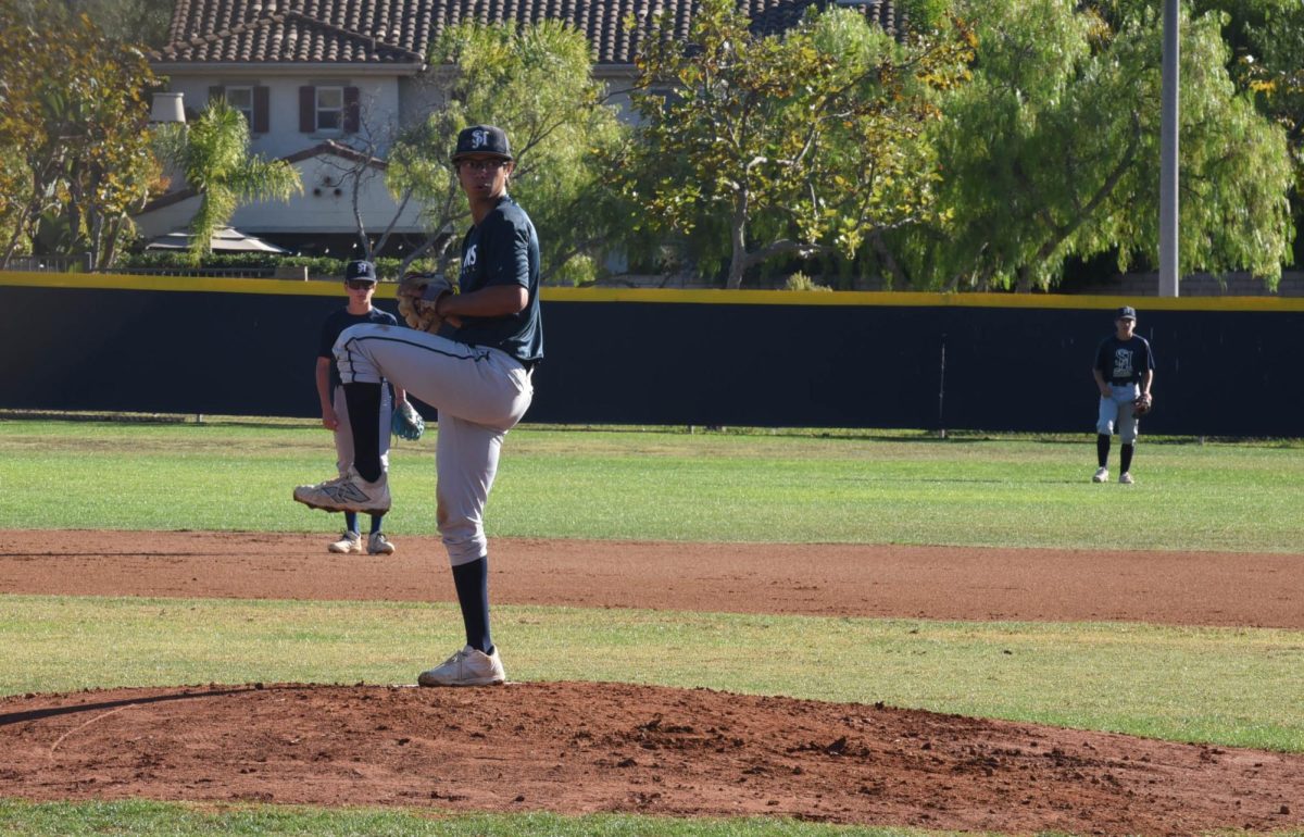  On the mound, Ryan Pimentel (12) prepares to pitch the ball to the batter. Pimentel played for ‘Team Reeves’ but lost in a close game to ‘Team Kessler’ 4-3.