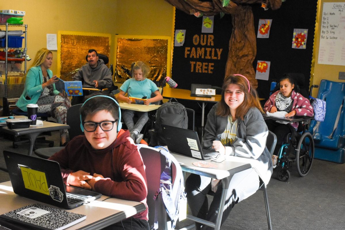 STEPS Kids Addison Hayes (12) and Paul Freeman (11) smile as they work on their chromebooks during first period. 
