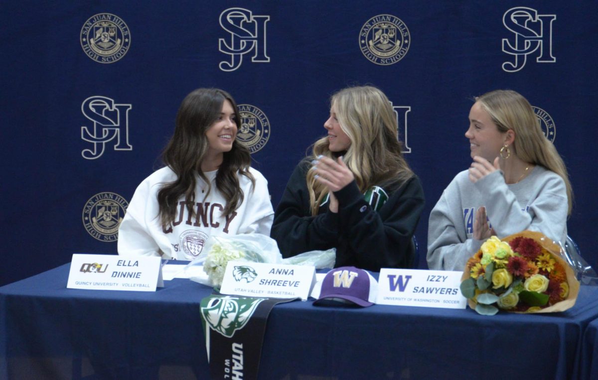 Friends of Ella Dinnie (12) celebrate as her future volleyball career at Quincy University is announced. She and several other successful athletes recently signed on to various sports teams at a variety of rigorous colleges. 