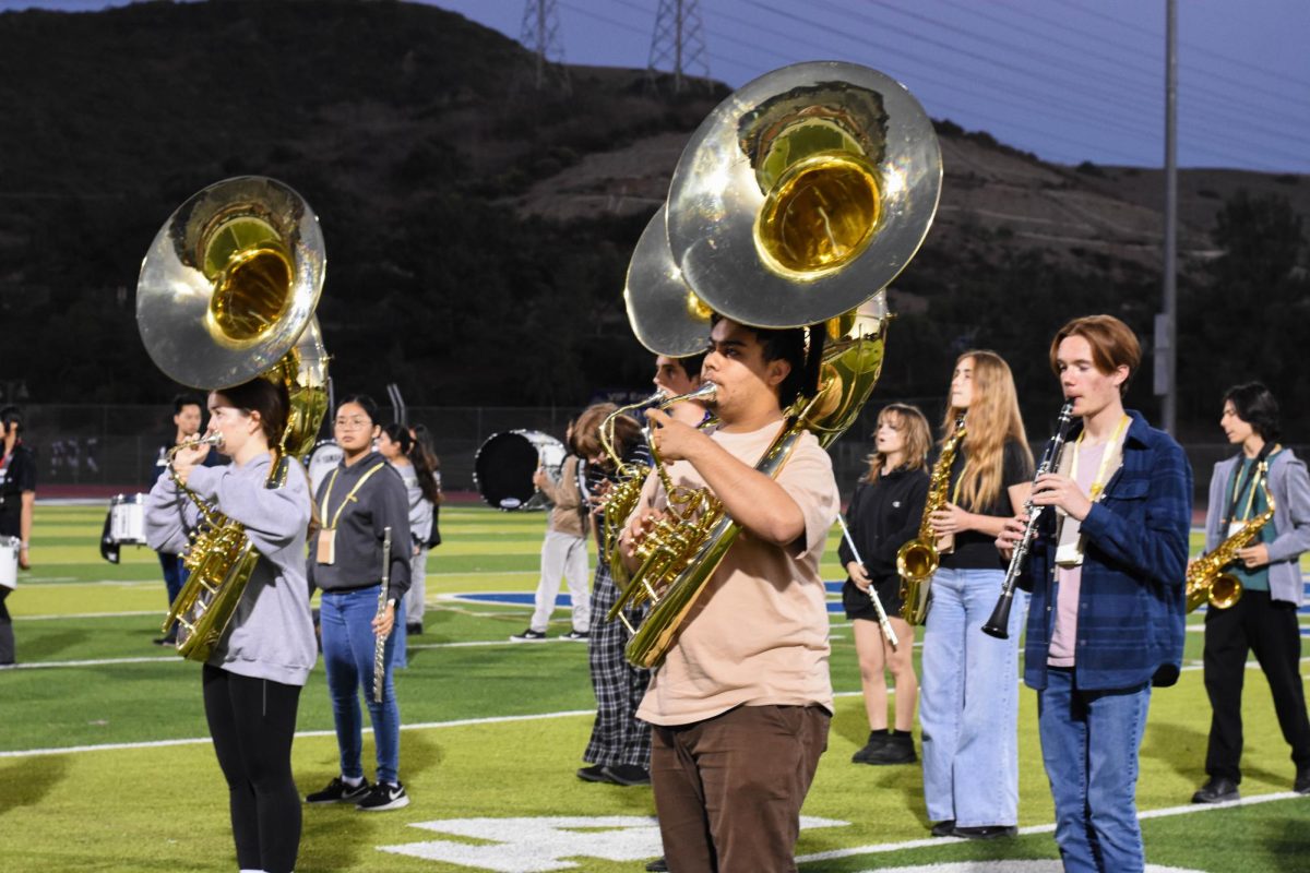 During practice, Jason Garcia (11) and to the left, Melissa Warner (12) practice the sousaphone with Kieran Meador (10) to the right playing the clarinet.