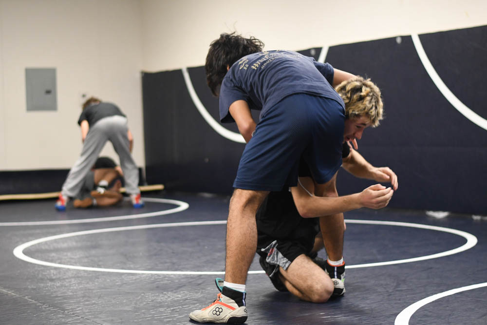 Noa Hernadez (11) is on the mats wrestling with Christan Garcia (9). Participating in wrestling practice to improve their skills. They do drills, sparring sessions, and activities to build their endurance and strength for upcoming tournaments