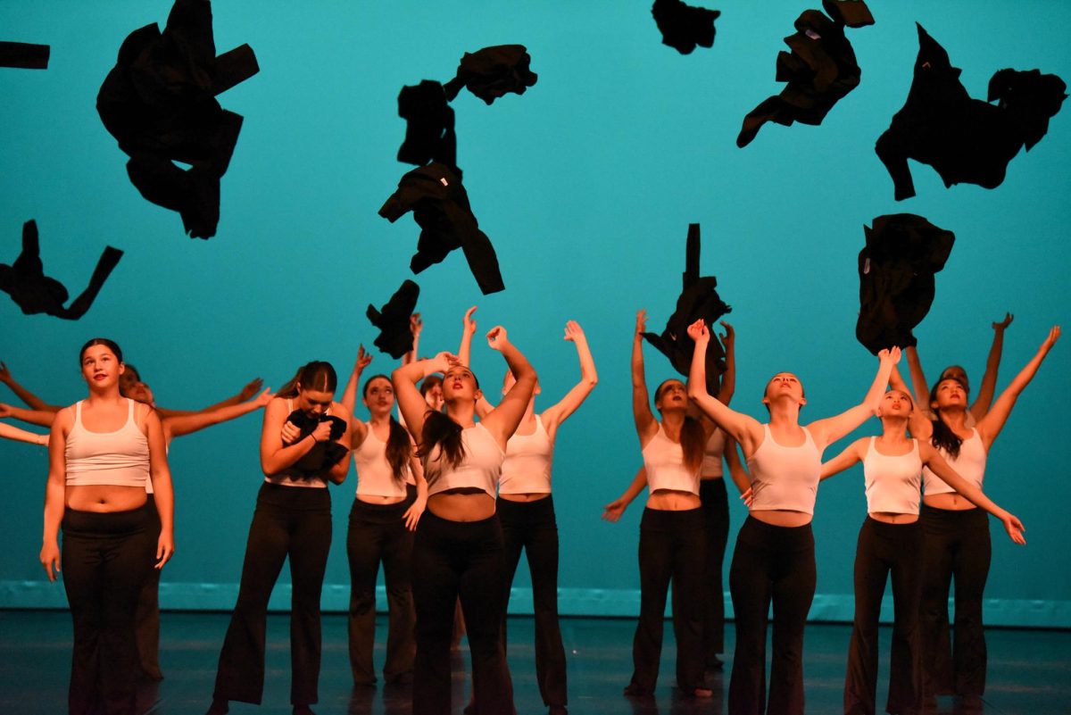  Performing their prepared routine Free, the beginning intermediate dance group including Charlotte Paxton (9), Hannah Sedgwick (11), Alex McNutt (9), Lila Jackson (10), Elie Degroot (10), Holly Brando (11), Queanna Nguyen (11), and Audrey Chi (10), all take off their propped costume for the crowning end of their dance as a metaphorical symbol of breaking free from conformity.